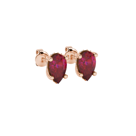 Close-up, pear shape raspberry red gemstone earrings, rose gold pavé basket.
