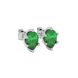 Close-up emerald green gemstone, white gold scalloped setting.