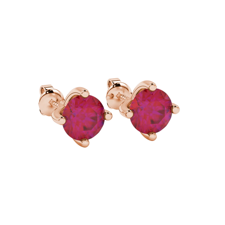 close-up shot of round raspberry red gemstone earrings with a rose gold four-prong design.