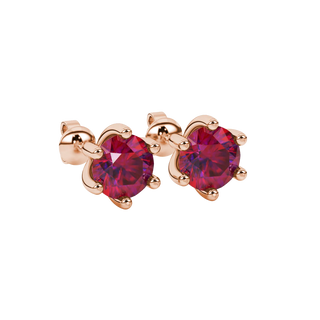 close-up shot of round raspberry red gemstone earrings with a rose gold six-prong design