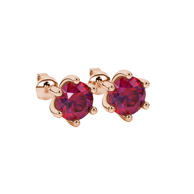 close-up shot of round raspberry red gemstone earrings with a rose gold six-prong design