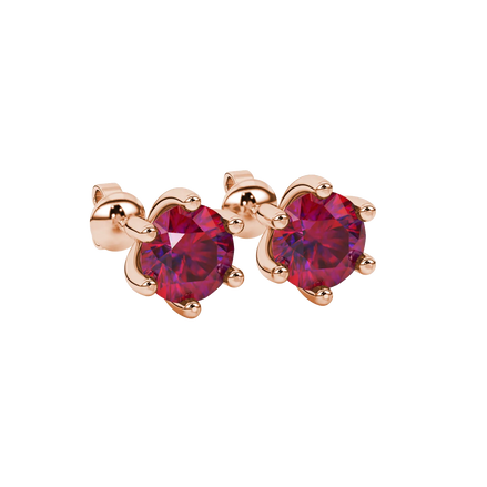 close-up shot of round raspberry red gemstone earrings with a rose gold six-prong design