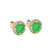 Close-up details of a round-cut emerald green gemstone in a yellow gold diamond French pavé halo.