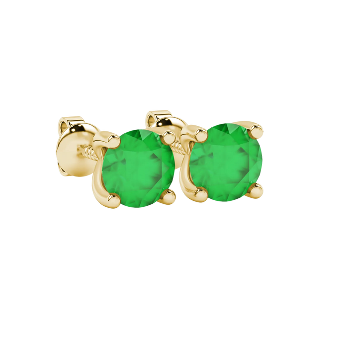 Close-up details of a round-cut emerald green gemstone in a yellow gold surprise diamond setting.