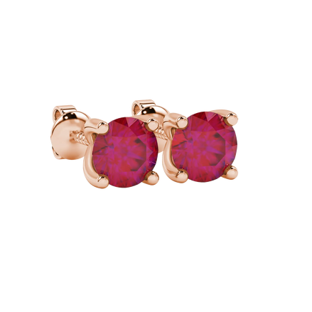 Close-up shot of round raspberry red gemstone earrings with a rose gold surprise diamond setting design.
