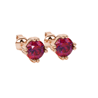 close-up shot of round raspberry red gemstone earrings with a rose gold vintage basket design.