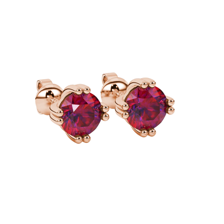 close-up shot of round raspberry red gemstone earrings with a rose gold vintage basket design.