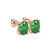 Close-up, oval cut emerald green gemstone earrings, rose gold four prong setting.