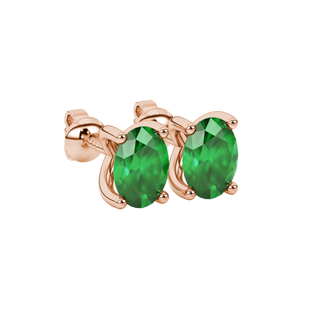 Close-up, oval cut emerald green gemstone earrings, rose gold four prong setting.