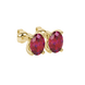 Close-up, oval cut raspberry red gemstone, yellow gold four prong earrings.