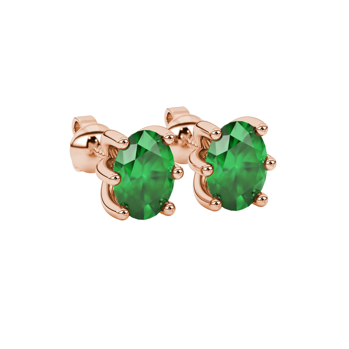 Close-up, oval cut emerald green gemstone earrings, rose gold six prong setting.