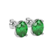 Close-up oval cut emerald green gemstone earing, white gold classic basket.