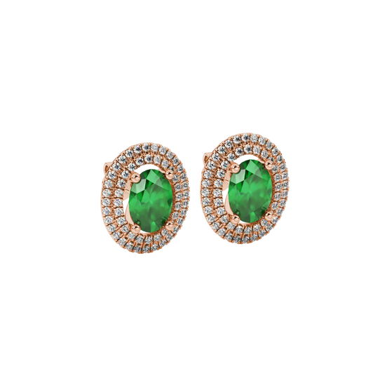 Close-up, oval cut emerald green gemstone earrings, rose gold double halo.