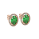 Close-up, oval cut emerald green gemstone earrings, rose gold french pavé halo.