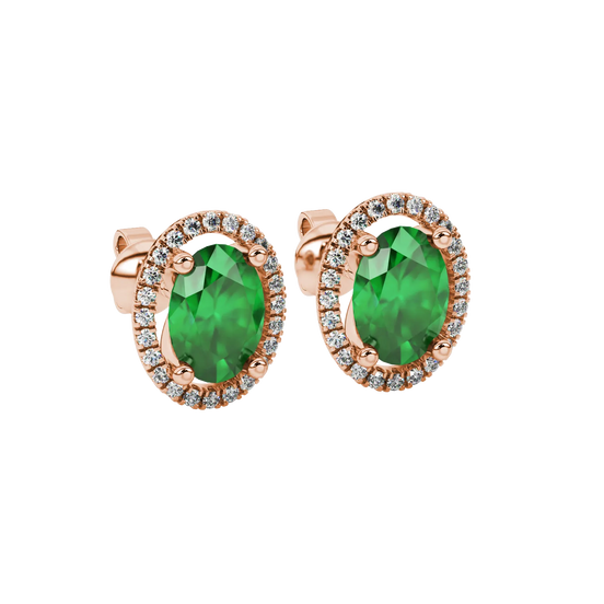 Close-up, oval cut emerald green gemstone earrings, rose gold french pavé halo.