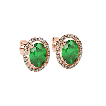 Close-up, oval cut emerald green gemstone earrings, rose gold french pavé halo.