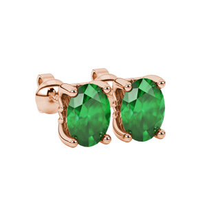 Close-up, oval cut emerald green gemstone earrings, rose gold lotus basket.