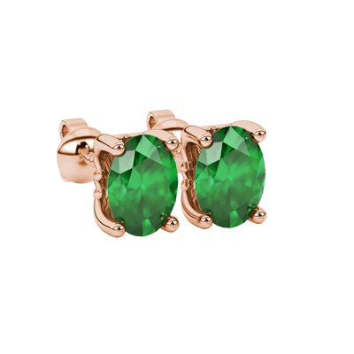 Close-up, oval cut emerald green gemstone earrings, rose gold lotus basket.