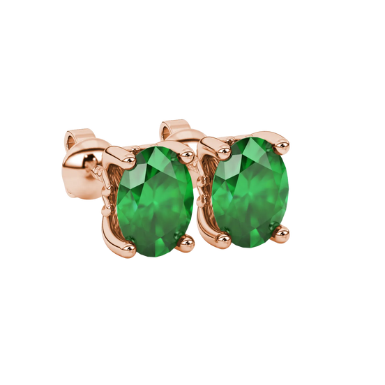 Close-up, oval cut emerald green gemstone earrings, rose gold lotus basket.