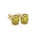 Close-up, oval cut canary yellow gemstone, yellow gold pavé basket earrings.