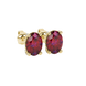 Close-up, oval cut raspberry red gemstone, yellow gold pavé basket earrings.