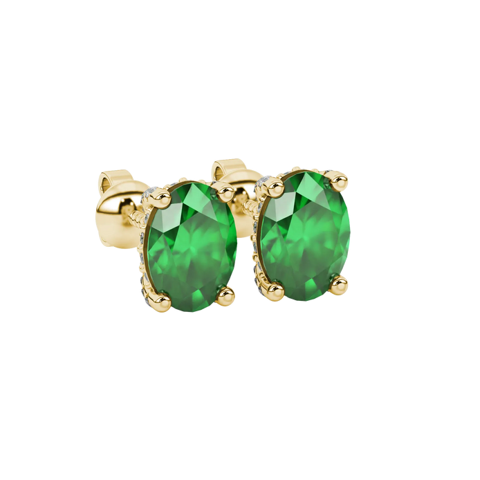 Close-up, oval cut emerald green gemstone, yellow gold pavé basket earrings.
