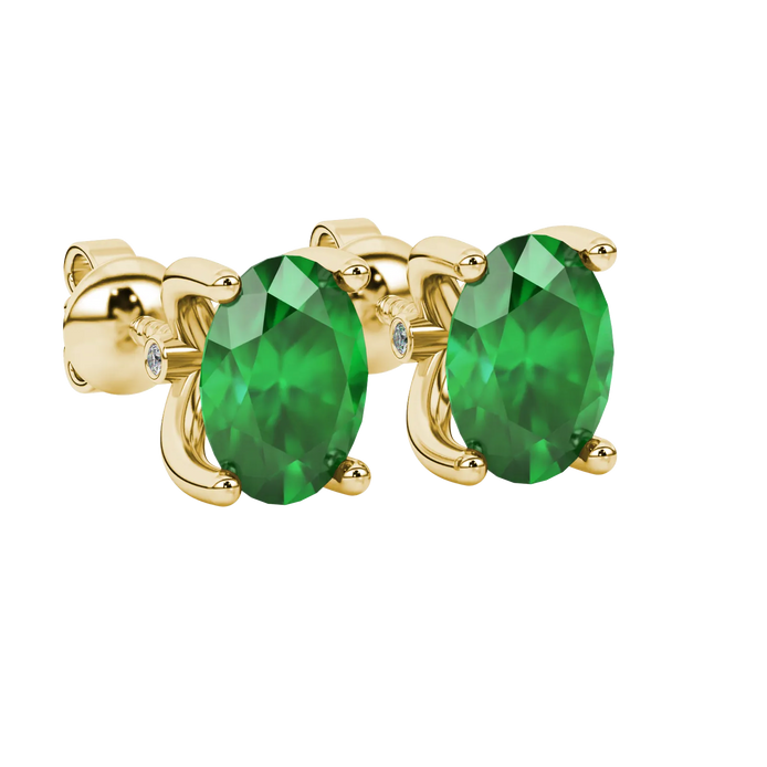 Close-up, oval cut emerald green gemstone, yellow gold surprise diamond earrings.