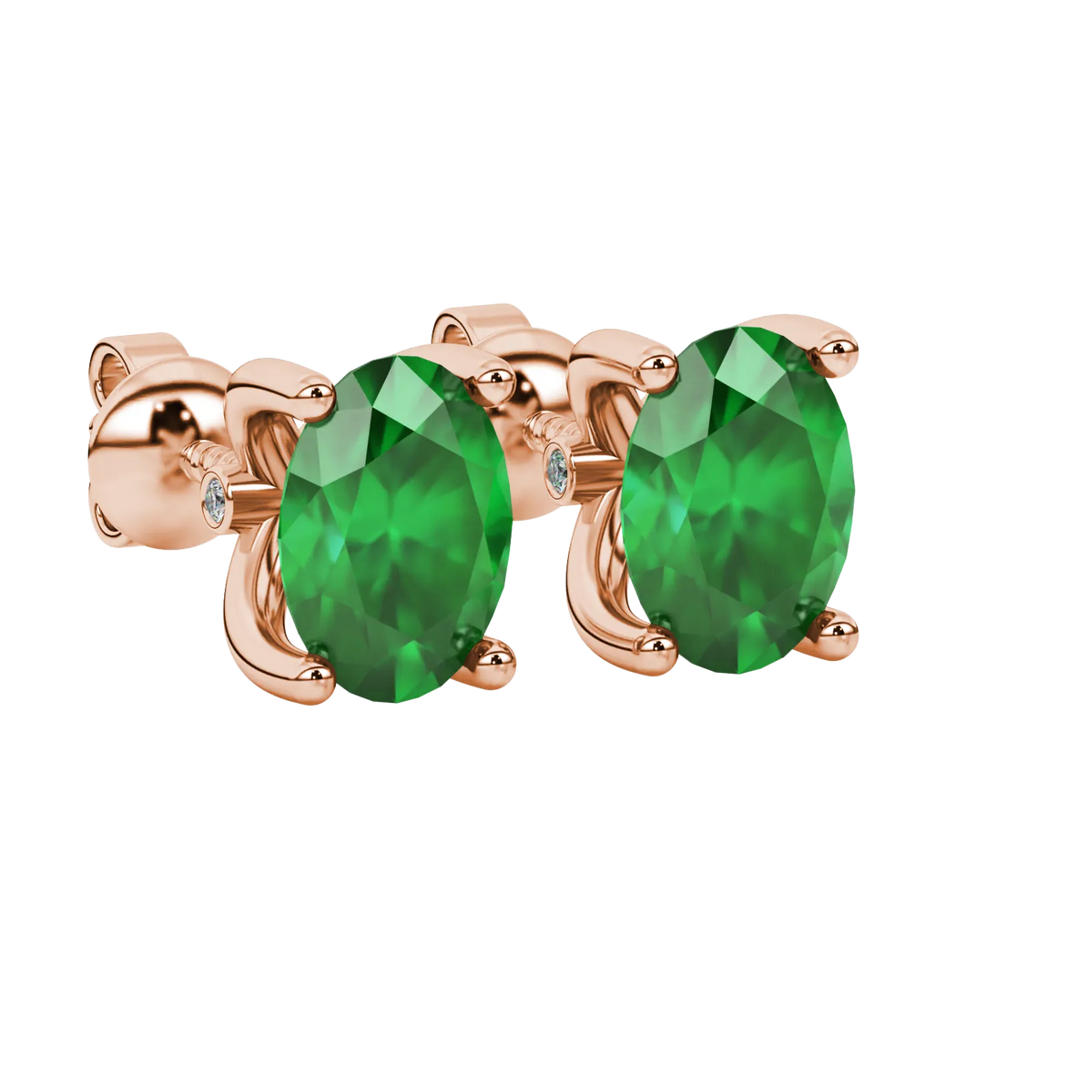 Close-up, oval cut emerald green gemstone earrings, rose gold surprise diamond setting.