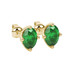 Close-up, oval cut emerald green gemstone, yellow gold tulip basket earrings.