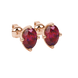 Close-up, oval cut raspberry red gemstone earrings, rose gold tulip basket.