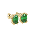 Close-up, oval cut emerald green gemstone, yellow gold vintage basket earrings.