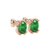 Close-up, oval cut emerald green gemstone earrings, rose gold vintage basket.