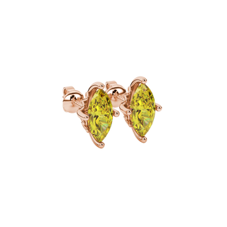 Close-up, marquise cut canary yellow gemstone earrings, rose gold lotus basket.