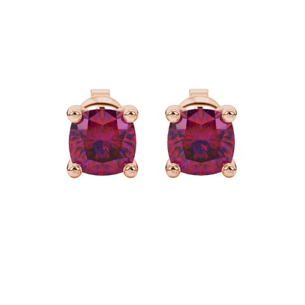 Red cushion cut gemstone solitaire stud earrings in gold featuring a refined four-prong basket setting