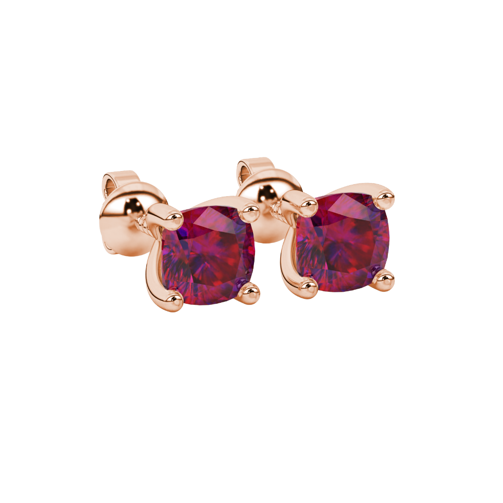 Red cushion cut gemstone solitaire stud earrings in gold featuring a refined four-prong basket setting