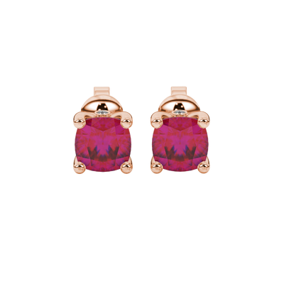Red cushion cut solitaire stud earrings with accent diamonds in white gold four prong setting
