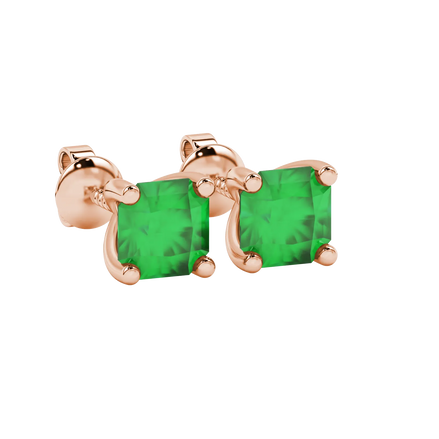 close-up shot of radiant-cut emerald green gemstone stud earrings with a classic rose gold four-prong setting