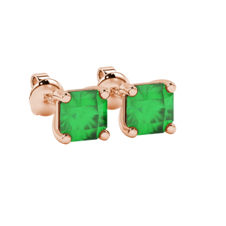 close-up shot of radiant-cut emerald green gemstone stud earrings with a rose gold classic basket gallery.