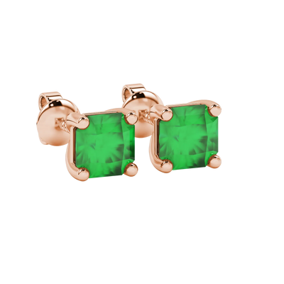 close-up shot of radiant-cut emerald green gemstone stud earrings with a rose gold classic basket gallery.