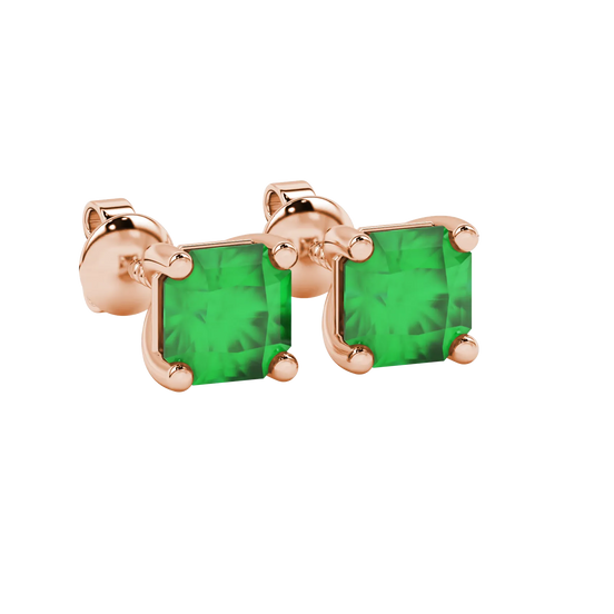 close-up shot of radiant-cut emerald green gemstone stud earrings with a rose gold classic basket gallery.