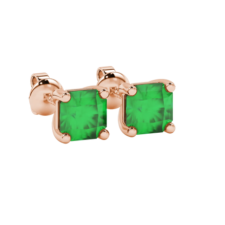 close-up shot of radiant-cut emerald green gemstone stud earrings with a rose gold classic basket gallery.