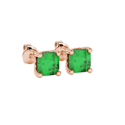 close-up shot of radiant-cut emerald green gemstone stud earrings with a rose gold lotus basket gallery.