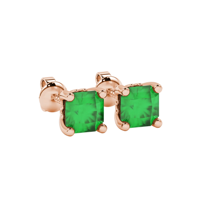 close-up shot of radiant-cut emerald green gemstone stud earrings with a rose gold lotus basket gallery.