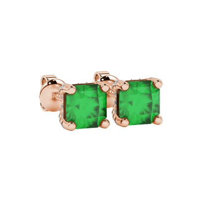 close-up shot of radiant-cut emerald green gemstone stud earrings with a rose gold pavé basket gallery.