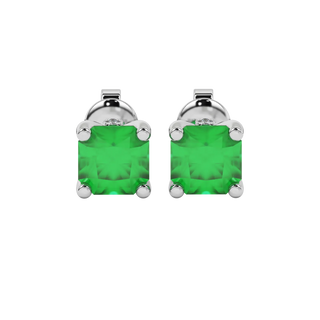 Radiant-cut emerald green gemstone stud earrings in a white gold surprise diamond setting.