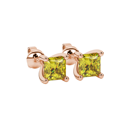 Close-up, princess canary yellow gemstone earrings, rose gold four-prong setting.