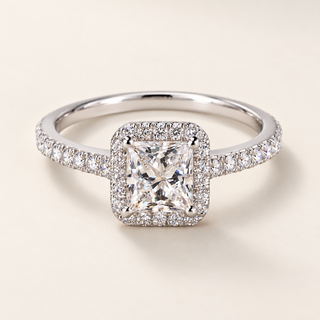 Princess cut lab grown diamond halo engagement ring in white gold with square center, rounded prongs and pavé diamond shoulders