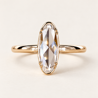 Moval rose cut lab grown diamond solitaire engagement ring in yellow gold with perimeter rails, paired side prongs and a plain band