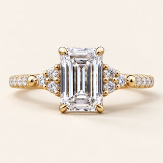 Emerald Cut Lab Grown Diamond Cluster Engagement Ring with round side diamonds in Yellow Gold