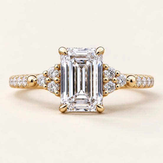 Emerald Cut Lab Grown Diamond Cluster Engagement Ring with round side diamonds in Yellow Gold